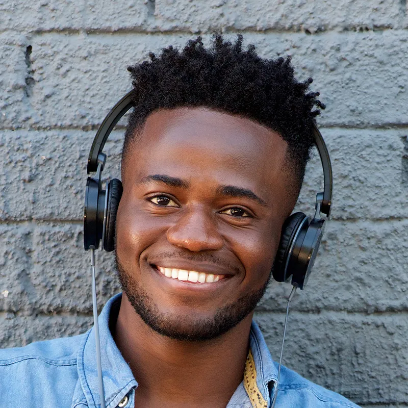 A smiling member of the Fibre Boyz team wearing headphones